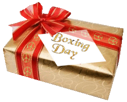gold gift with red bow, peace sign ribbon, tagged boxing day